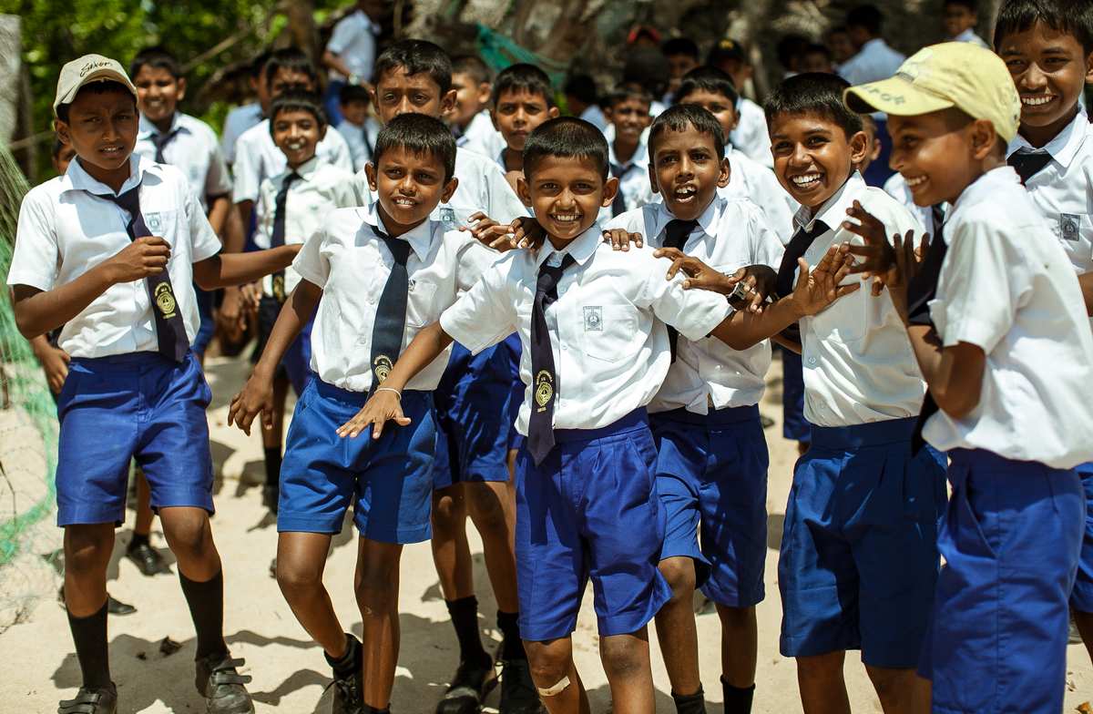 School children in uniform playing together in a schoolyard